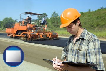 a civil engineer inspecting a road building project - with Wyoming icon